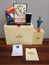 A Guinness composition figure 200 Keeper and a Toucan clock ceramic, boxes with certificates
