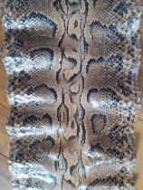 A vintage snakeskin roll measuring 180"x 17" (at widest point), probably python. Location:BWR