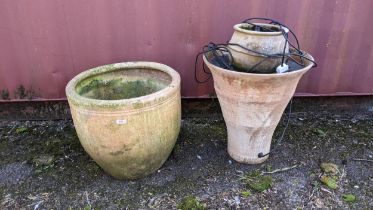 A modern large garden pot along with a garden water feature Location: Bluecon