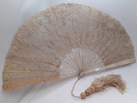 A 19th Century Continental mother of pearl and cream lace fan with tassel to the handle. Location: