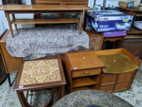 A mid-century teak coffee table with undertier, a teak telephone seat with drawer, open shelves, and