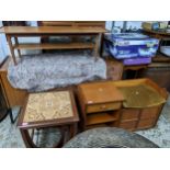 A mid-century teak coffee table with undertier, a teak telephone seat with drawer, open shelves, and