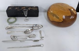 Silver plated flatware to include a basting spoon, Stilton scoop and marrow scoop, a black lacquered