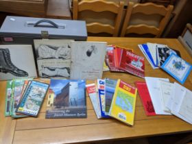 A filing box containing various theatre programmes, folding maps, and gallery exhibition