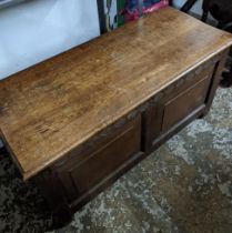 An 18th century oak chest with a later top Location: G