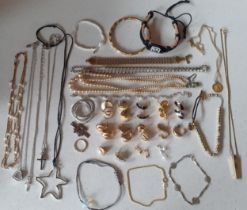 A quantity of mainly modern costume jewellery to include silver tone Swarovski crystal pendants on