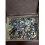 A wooden box containing a selection of vintage keys and a brass padlock Location: