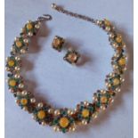 Christian Dior-A 1959 necklace and later matched 1962 clip-on earrings having a silver toned