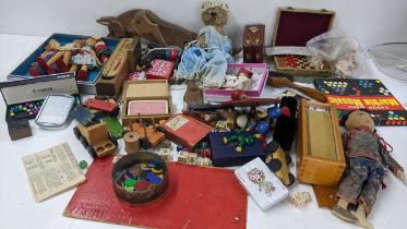 A mixed lot to include playing cards, boxed miniature chess set, dolls and other various toys and