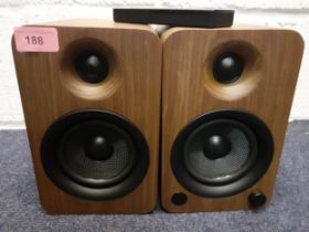 A pair of Kanto walnut cased powered speakers with bluetooth and built-in phono pre-amp, 140W