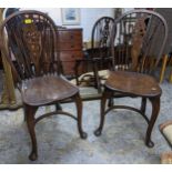 Two 20th century elm seated Windsor wheel back chairs with crinoline elliptical and stretchers,