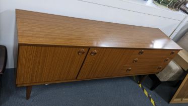 A mid 20th century retro Schreiber sideboard having two cupboard doors and three drawers, 73cmh x