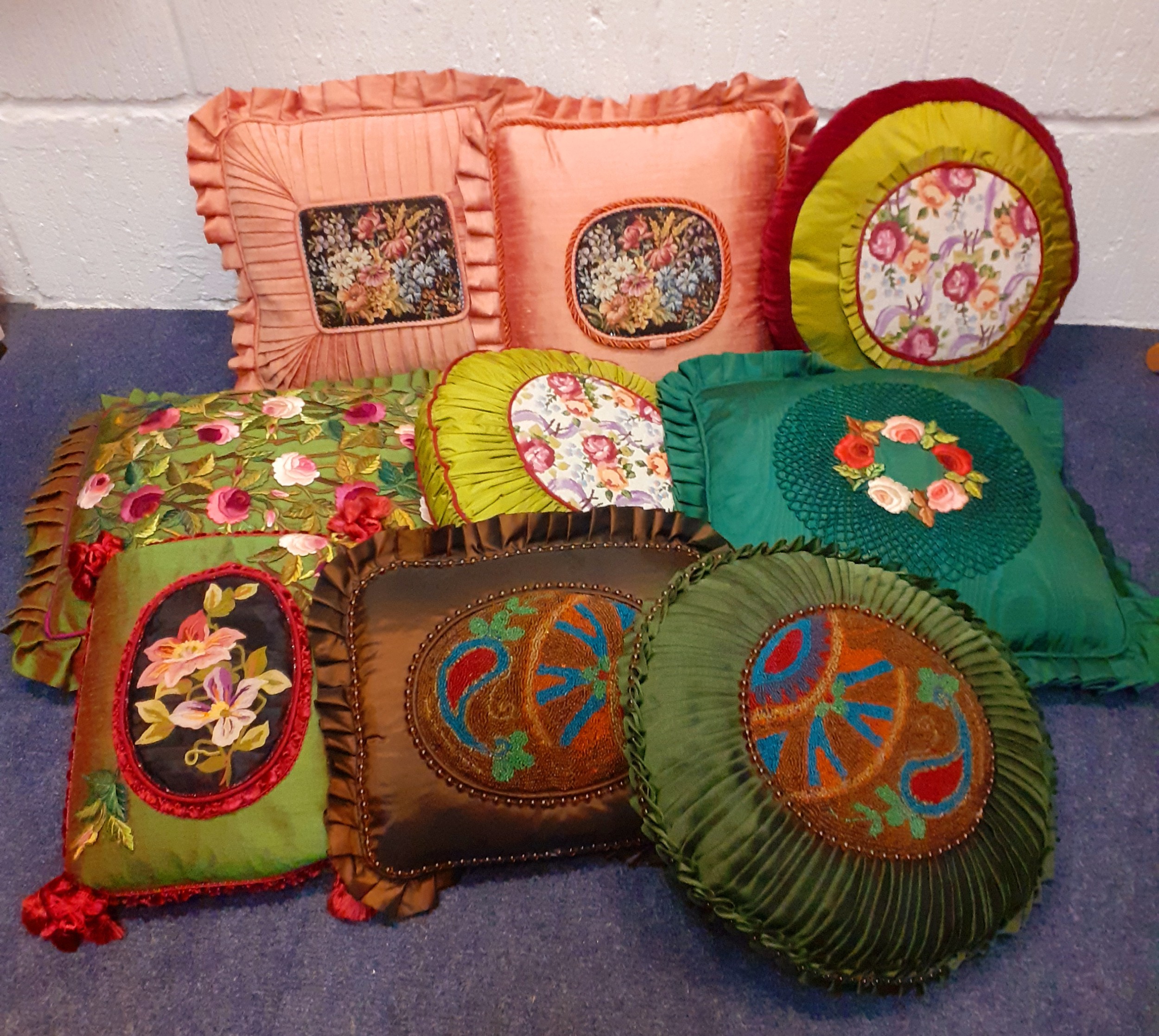 Nine vintage bespoke cushions to include embroidered, silk and beaded examples. Location: