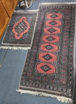 A Pakistani hand woven runner with elephant foot motifs and tasselled ends, 190cm x 81.5cmw,