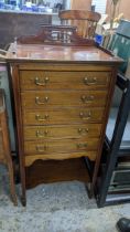 Edwardian inlaid mahogany music cabinet of five drawers over an undertier, on square tapering