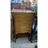 Edwardian inlaid mahogany music cabinet of five drawers over an undertier, on square tapering