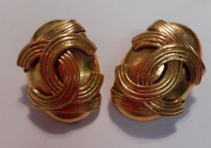 A pair of gold tone clip on earrings in the style of a French designer. Location:Cab