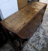 An early 18th century oak drop leaf dining table on turned block legs Location: G