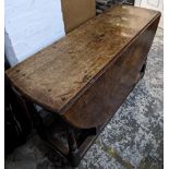 An early 18th century oak drop leaf dining table on turned block legs Location: G