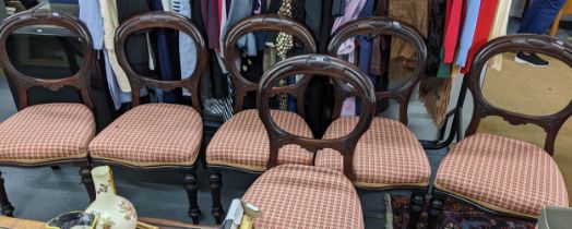 A set of six Victorian mahogany balloon back dining chairs with overstuffed upholstered seats