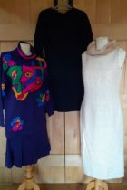 Three outfits comprising an Escada purple knit 2-piece with colourful mask design to the jumper