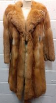 A late 1970's/early 1980's red fox calf length coat A/F with shawl collar, having a vertical