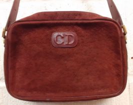 Christian Dior- A late 1970's/early 1980's shoulder bag in oxblood suede and leather having the Dior