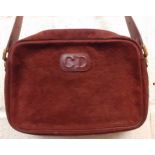 Christian Dior- A late 1970's/early 1980's shoulder bag in oxblood suede and leather having the Dior