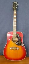 A Columbus Hummingbird acoustic 6-string guitar model no:WH-59, having a cherry sunburst design,