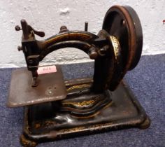 A 19th Century cast iron hand cranked sewing machine with gilt decoration, rubber intact. Location: