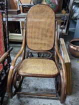 An early 20th century Thonet style bentwood and cane rocking chair, incised stamped '18' to base