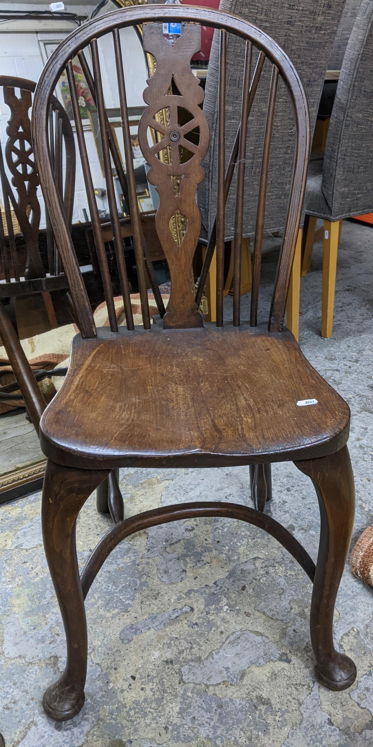 Two 20th century elm seated Windsor wheel back chairs with crinoline elliptical and stretchers, - Image 2 of 3