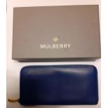 Mulberry- A mid blue leather purse having gold tone hardware and punched hole outline of the