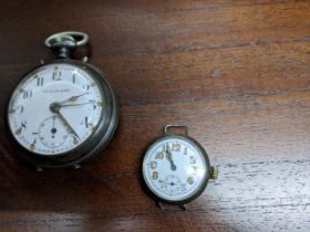 An early 20th century metal cased The Glow Worm pocket watch, white enamel dial with Arabic
