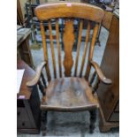 A late 19th century ash and elm Windsor armchair with shaped central splat, arms with out swept