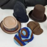 A group of mainly mid 20th Century hats to include a tall domed brown felt bowler hat, size 56, a