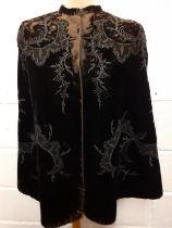 A late 19th Century Madame Garnier et Cie black velvet cape A/F with black beadwork design and