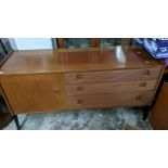 A Nathan mid-century teak sideboard, three graduated drawers and cupboard door with brass handles,