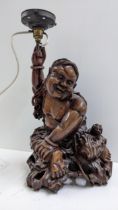 A Chinese root carved figural table lamp of a seated man in a naturalistic setting, 44cm h Location: