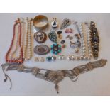 A quantity of vintage costume jewellery to include a carved ivory style necklace with matching