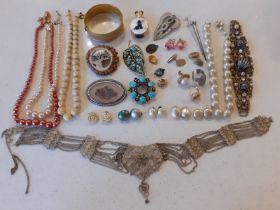 A quantity of vintage costume jewellery to include a carved ivory style necklace with matching