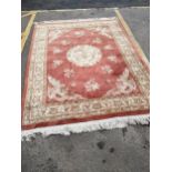 A group of three machine woven Chinese style rugs, the largest decorated with a dragon medallion