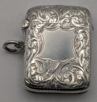 A silver vesta case with engraved floral decoration and a gilt interior hallmarked Birmingham