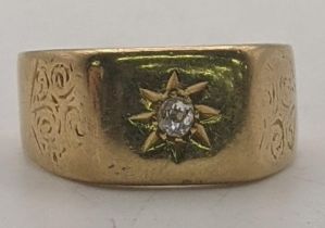 A 18ct gold gents Starburst signet ring set with a central diamond, engraved floral design, size R