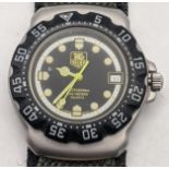 A Tag Heurr gents quartz wristwatch on a green Apollo strap Location: