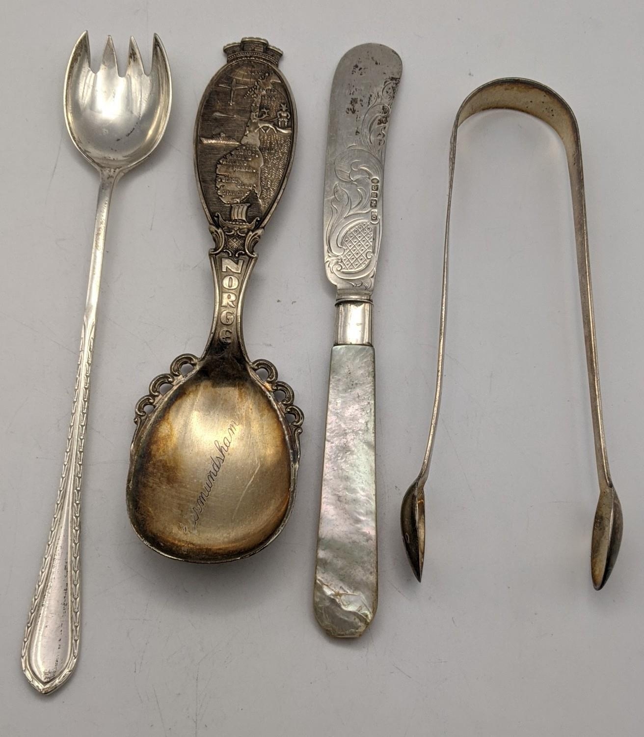 Silver flatware to include an elongated fork, sugar tongs, a Norwegian spoon 108g, and a mother of