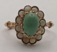 A gold coloured ring set with a green cabochon and opals tested as 14ct, 3.4g Location: