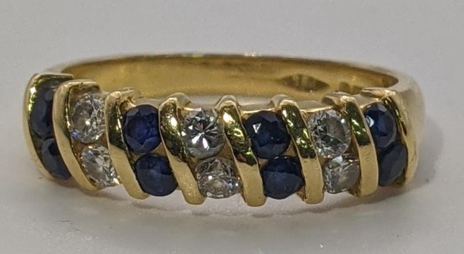 An 18ct gold diamond and sapphire ring 4.4g Location: