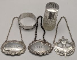 Three silver decanter labels to include a Whisky label, and others, together with a napkin ring