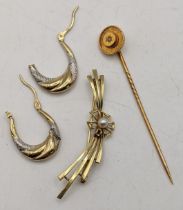 A gold bar brooch stamped 585, 3.5g together with a yellow metal stick pin set with a diamond and